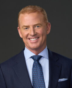 a man in a suit and tie smiles for the camera